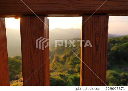 Spider web fence, sunset sky, mountains, forest 129007871