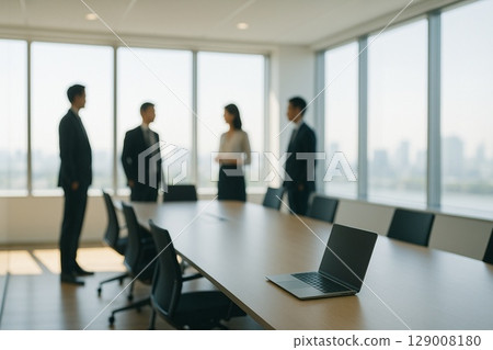 Silhouettes of business people having a meeting in a modern office | With space 129008180