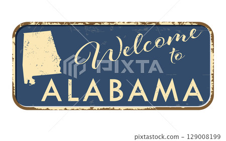 Welcome to Alabama. A worn blue plaque with the name and outline of the state. Welcome inscription on the road sign 129008199