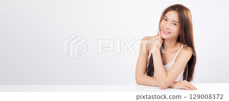 Skin smooth and radiant skin frame this Asian woman lovely face with gentle makeup ideal for skincare beauty or cosmetic product marketing isolated on studio white background 129008372