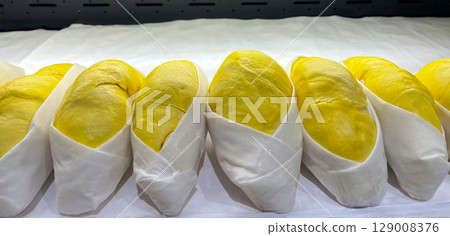 Premium Thai durian neatly displayed for sale in a modern supermarket. 129008376