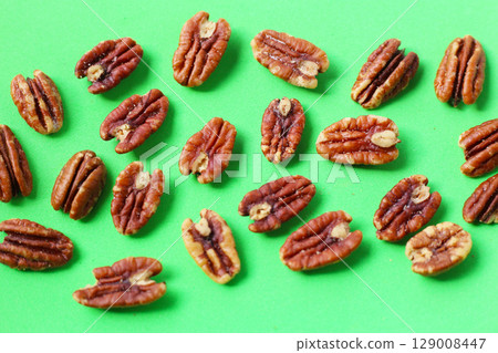 Delicious salted pecan nuts scattered. 129008447