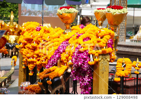 Marigold flower garlands offered for worship at the Erawan Shrine in Bangkok, Thailand. Marigold flower garlands offered for worship at the Erawan Shrine in Bangkok, Thailand. 129008498