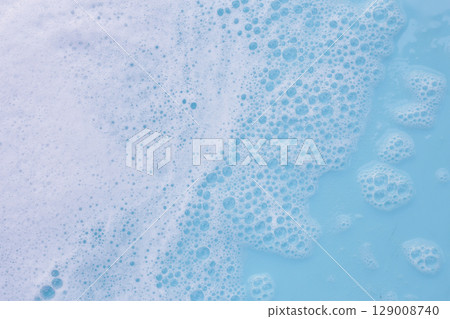 Blue water with white foam bubbles 129008740