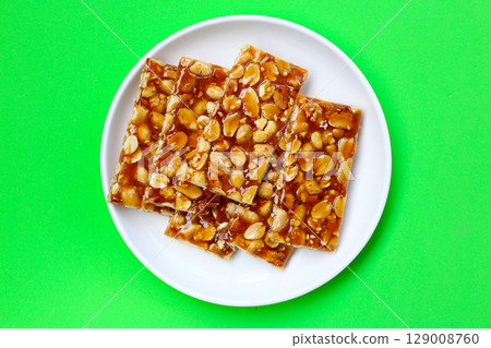 Peanut bars with sweet caramel 129008760