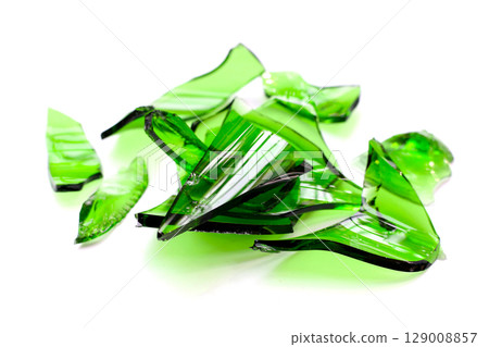 Sharp green glass shards scattered on a white background. Sharp green glass shards scattered on a white background. 129008857