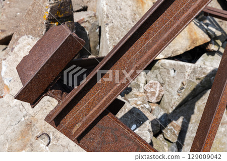 Close-Up of Rusty Metal Beams on a Rocky Background 129009042