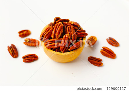 Delicious salted pecan nuts scattered. 129009117