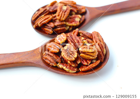 Delicious salted pecan nuts scattered. Delicious salted pecan nuts scattered. 129009155
