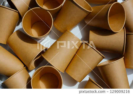 Brown paper cups on white background. 129009216