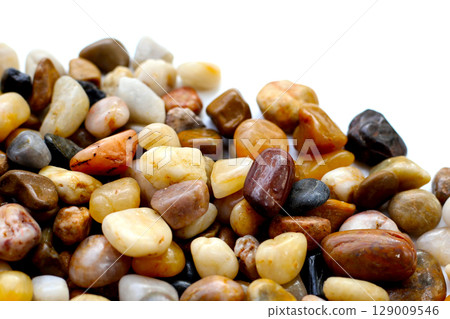 Small colorful pebbles on a white background. 129009546