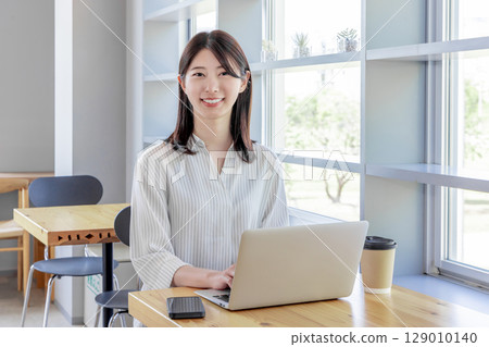 Young female cafe smartphone coworking share office Young female cafe smartphone coworking share office 129010140