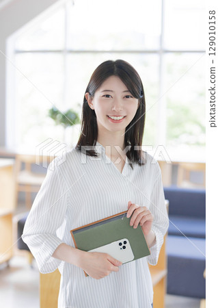 A woman working in a designer's office 129010158