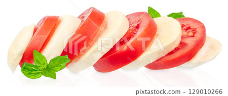 Slices of fresh tomato and mozzarella with basil leaves arranged in a Caprese-style composition on a white background Slices of fresh tomato and mozzarella with basil leaves arranged in a Caprese-style composition on a white background 129010266