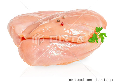 Raw chicken breasts with peppercorns and parsley on a white background 129010443