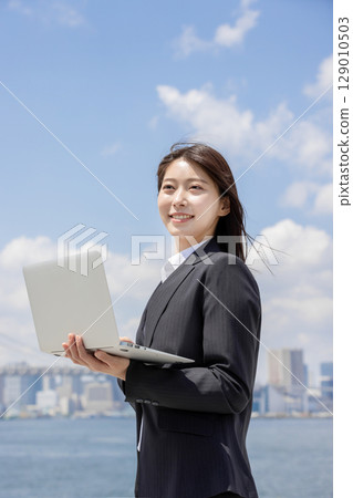 Businesswoman checking on laptop Businesswoman checking on laptop 129010503