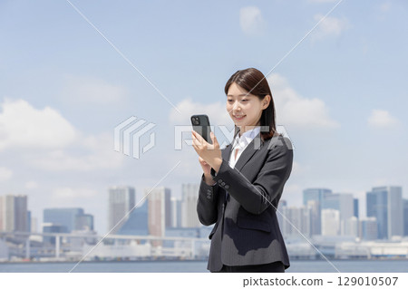 Business woman using smartphone Business woman using smartphone 129010507