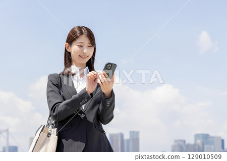 Business woman checking on smartphone Business woman checking on smartphone 129010509