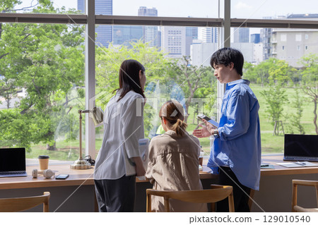 Designer's office, fresh greenery, buildings, blue sky, windows 129010540