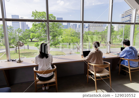 Designer's office, fresh greenery, buildings, blue sky, windows Designer's office, fresh greenery, buildings, blue sky, windows 129010552