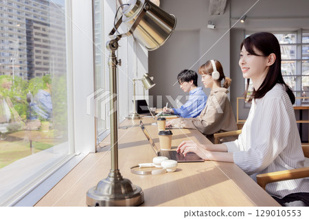 People working in coworking spaces People working in coworking spaces 129010553