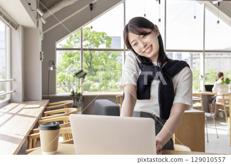 A woman working in a cafe A woman working in a cafe 129010557