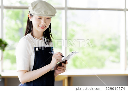 Cafe staff taking orders Cafe staff taking orders 129010574