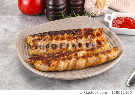 Grilled meat sausages wrapped bacon Grilled meat sausages wrapped bacon 129011160