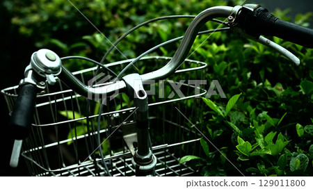 Handlebars of a bicycle parked on the side of the road 129011800