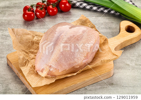 Raw chicken breast with bone 129011959