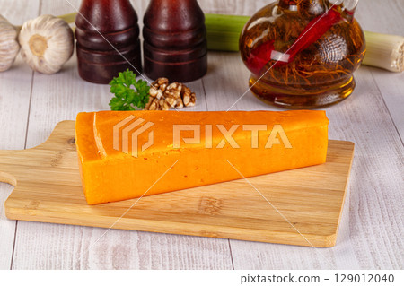 Yellow cheddae cheese over board Yellow cheddae cheese over board 129012040