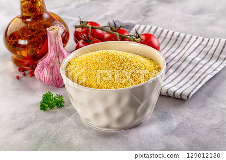 Vegan cuisine - raw dry couscous Vegan cuisine - raw dry couscous 129012180