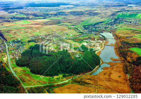 Aerial view of autumn Stradch village, church of the Dormition of the Mother of God, lake, green pine forests in Ukraine Aerial view of autumn Stradch village, church of the Dormition of the Mother of God, lake, green pine forests in Ukraine 129012285