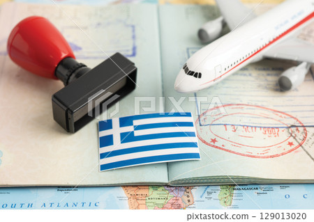 Approved Stamp passport with Greece, flag document to immigration at airport in country. 129013020