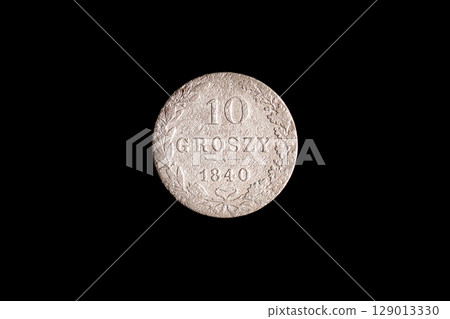 An authentic, old 10 groszy coin from Poland, dated 1840, precisely isolated on a sleek black background. This image evokes historical money and business concepts An authentic, old 10 groszy coin from Poland, dated 1840, precisely isolated on a sleek black background. This image evokes historical money and business concepts 129013330