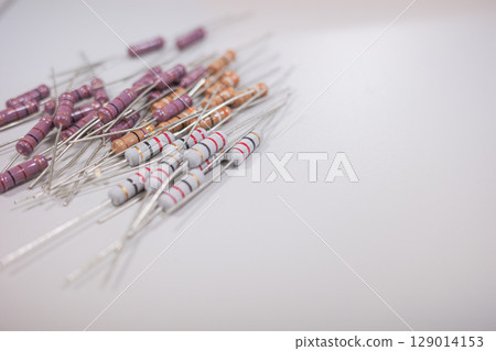 Assorted Through Hole Resistors on white background Assorted Through Hole Resistors on white background 129014153