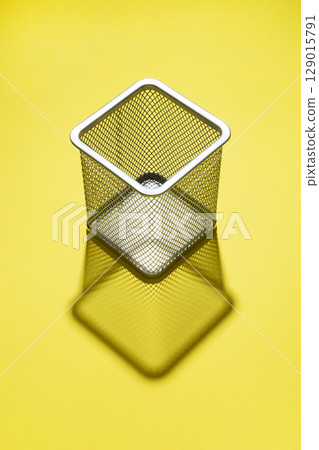 Abstract still life with a metal cup stand for pens and pencils Abstract still life with a metal cup stand for pens and pencils 129015791