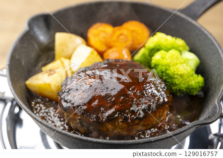 Hot demi-glace hamburger steak cooked in a skillet 129016757