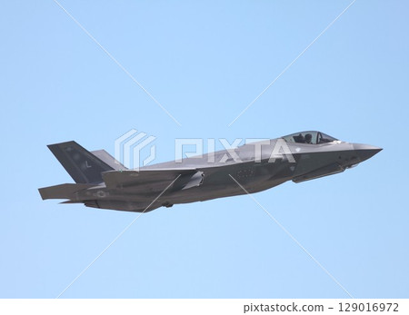 A US Air Force F-35A Lightning II stealth fighter jet flying in a clear blue sky A US Air Force F-35A Lightning II stealth fighter jet flying in a clear blue sky 129016972
