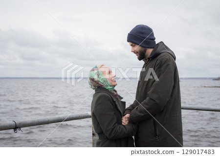 Smiling lovers man and woman outdoors portrait 129017483