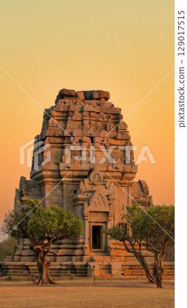 Ancient Temple in Golden Hour, Spiritual Journey, Tranquility, Architectural Beauty. Ideal for cultural tourism, historical sites, wellness, vertical shot 129017515