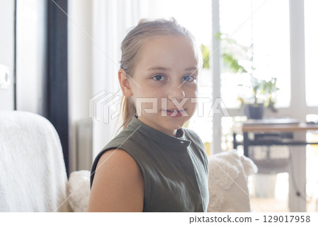 Little child girl sitting at home, indoor portrait Little child girl sitting at home, indoor portrait 129017958