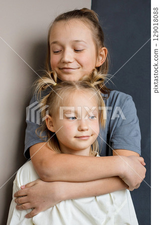 Cheerful children little girl and boy together at home. Sibling indoor, childhood concept Cheerful children little girl and boy together at home. Sibling indoor, childhood concept 129018088