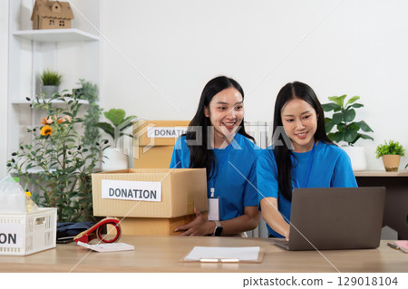 Volunteers Collaborating on Donation Projects with Enthusiasm 129018104