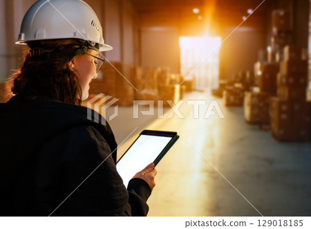 Young woman is working in warehouse Young woman is working in warehouse 129018185