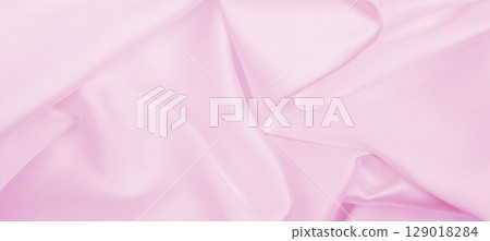 Smooth elegant pink silk or satin texture as wedding background. Luxurious background design 129018284