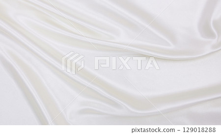 Smooth elegant white silk or satin luxury cloth texture as wedding background. Luxurious background design 129018288