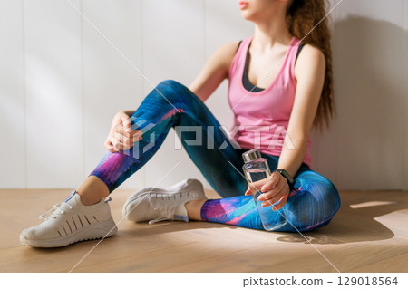 Woman in fashionable sportswear is doing exercise. 129018564