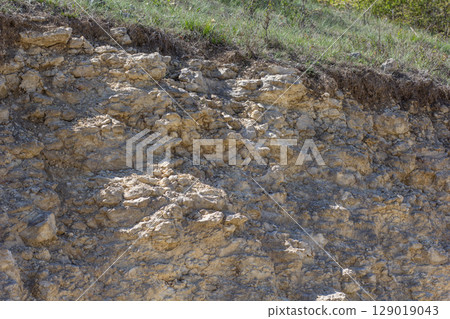 Eroded Limestone Cliff with Grass Top 129019043