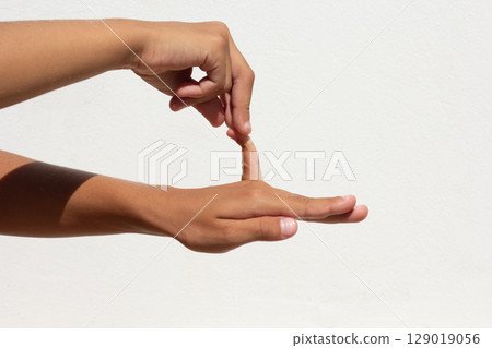 Child showing flexible little finger on white background Child showing flexible little finger on white background 129019056